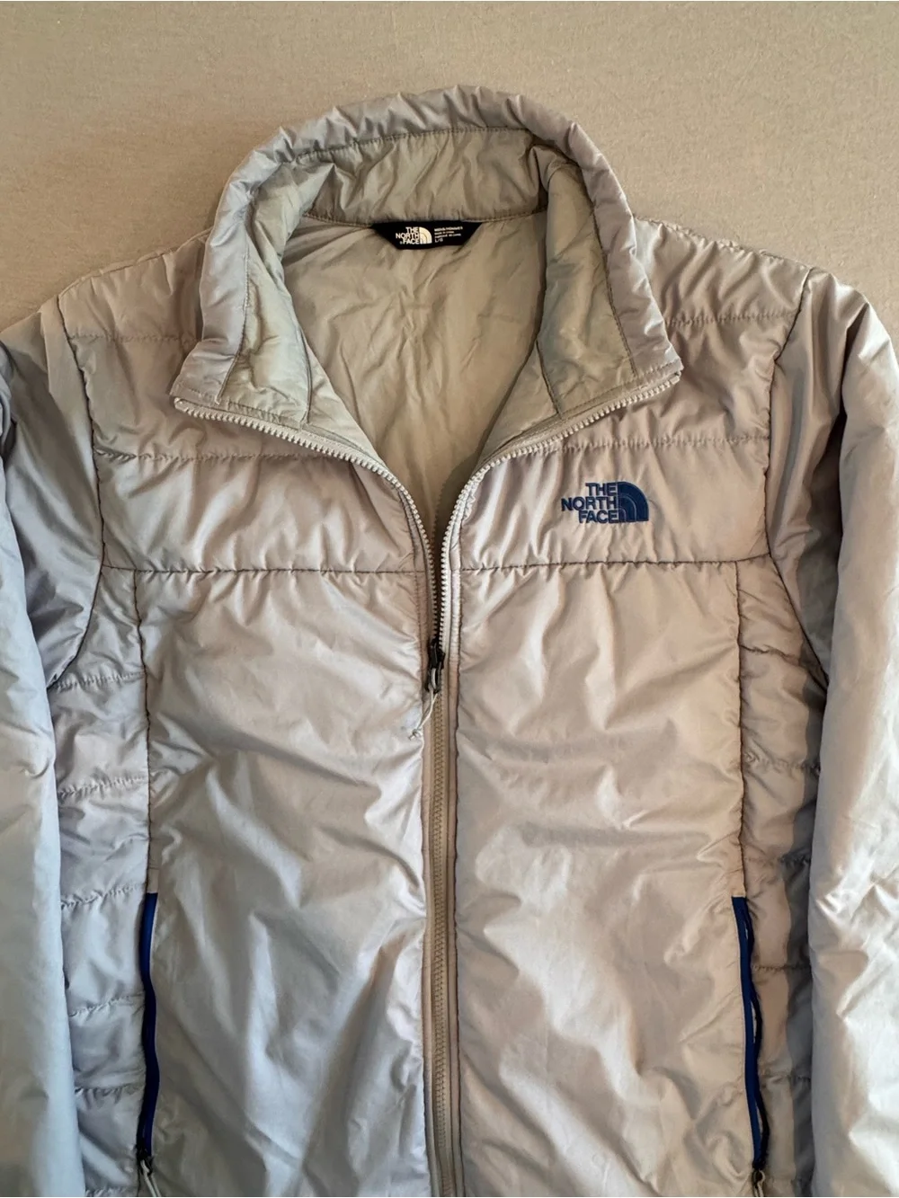 The North Face Light Gray Men's Puffer Jacket with Blue Accents
